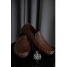 Brown Leather Shoes on a Brown Rattan Surface