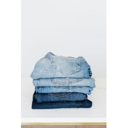copy of Stack of jeans on white shelf