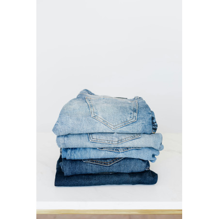 copy of Stack of jeans on white shelf